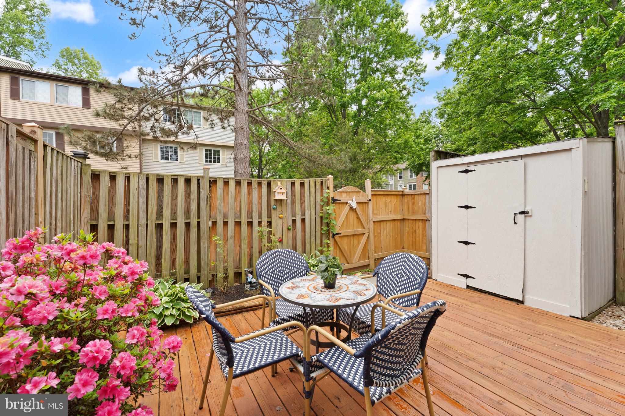 1617 Sierra Woods Drive Reston, VA 20194 - Photo 4 of 39 a backyard of a house with table and chairs wooden floor and fence