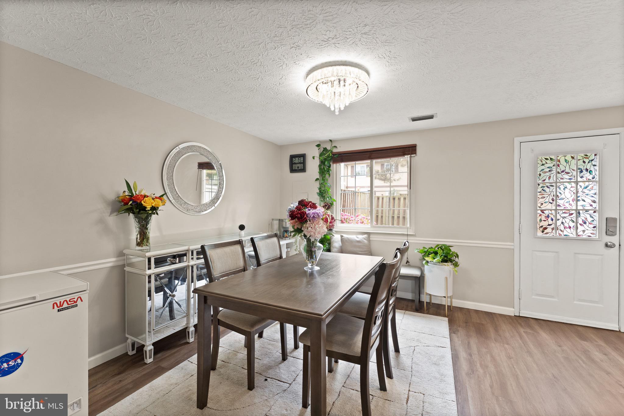 1617 Sierra Woods Drive Reston, VA 20194 - Photo 10 of 39 a view of a dining room with furniture and a potted plant