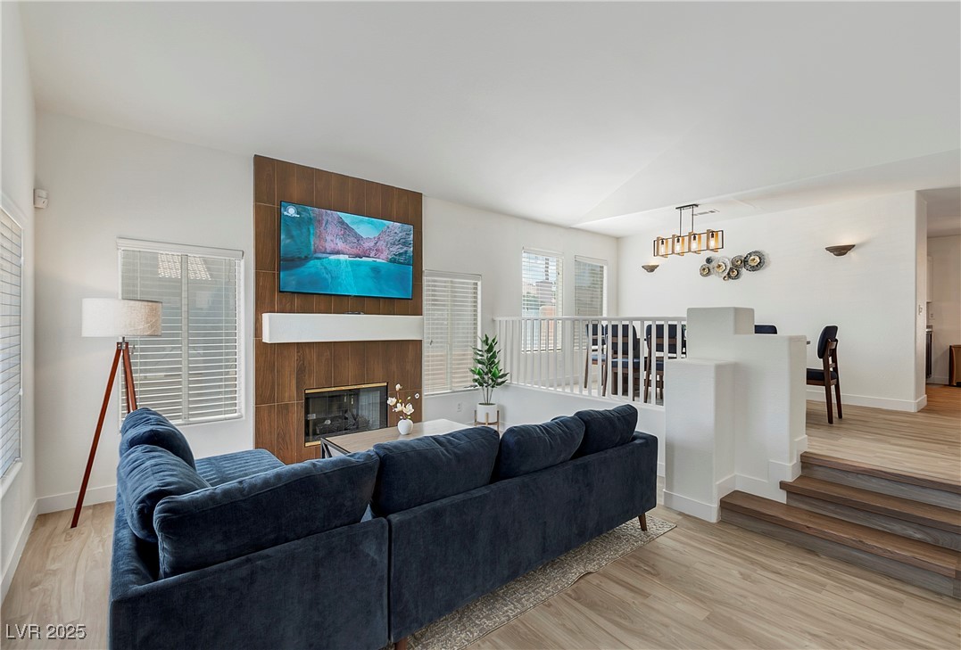 9156 Sapphire Point Avenue Las Vegas, NV 89147 - Photo 1 of 18 Living area featuring a large fireplace, light woo