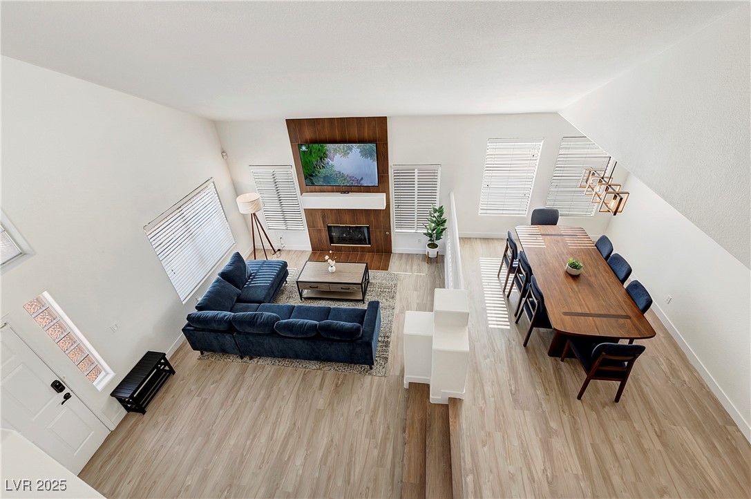 9156 Sapphire Point Avenue Las Vegas, NV 89147 - Photo 3 of 18 Living area featuring baseboards, vaulted ceiling,