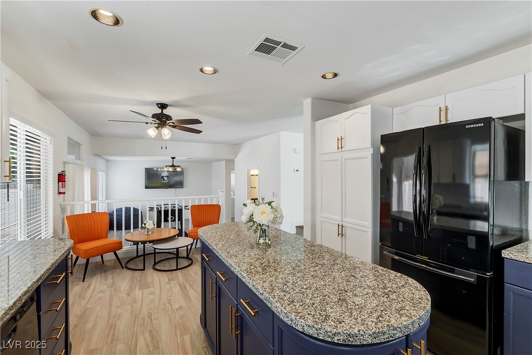 9156 Sapphire Point Avenue Las Vegas, NV 89147 - Photo 6 of 18 Kitchen featuring white cabinetry, visible vents,