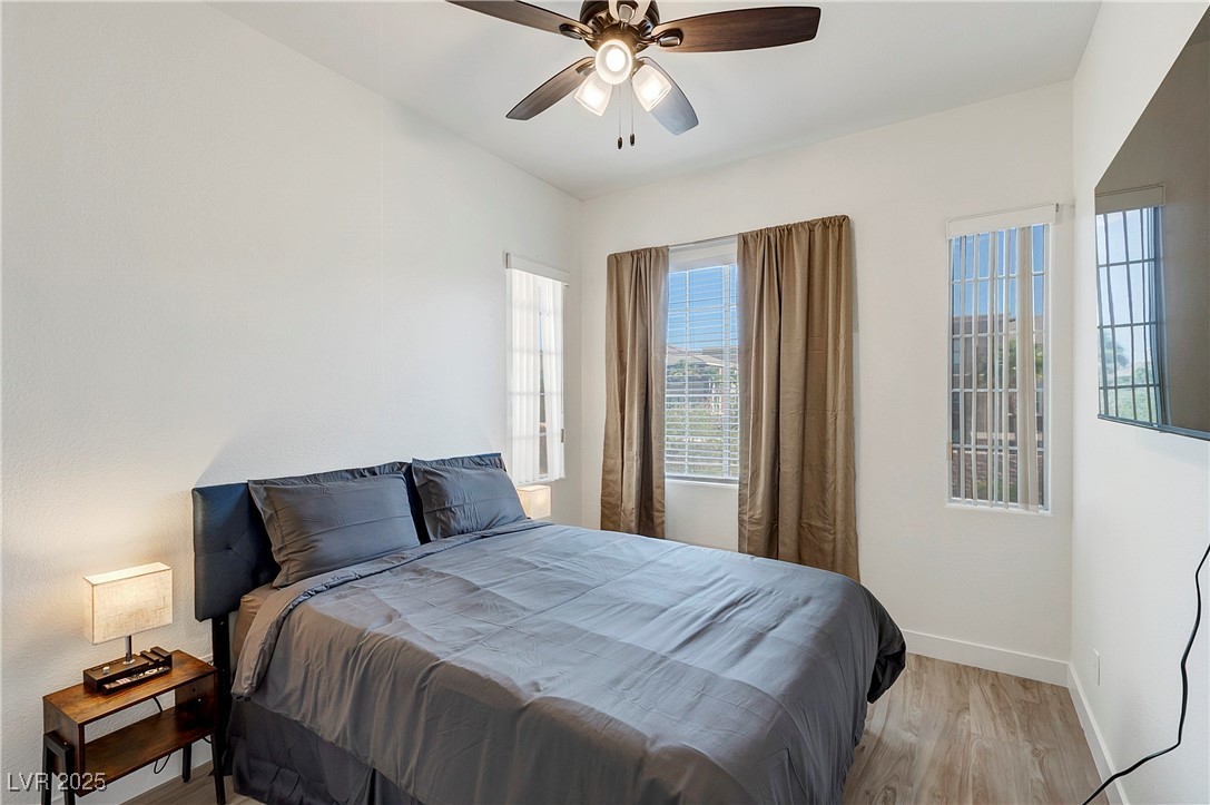 9156 Sapphire Point Avenue Las Vegas, NV 89147 - Photo 9 of 18 Bedroom with ceiling fan, light wood finished floo