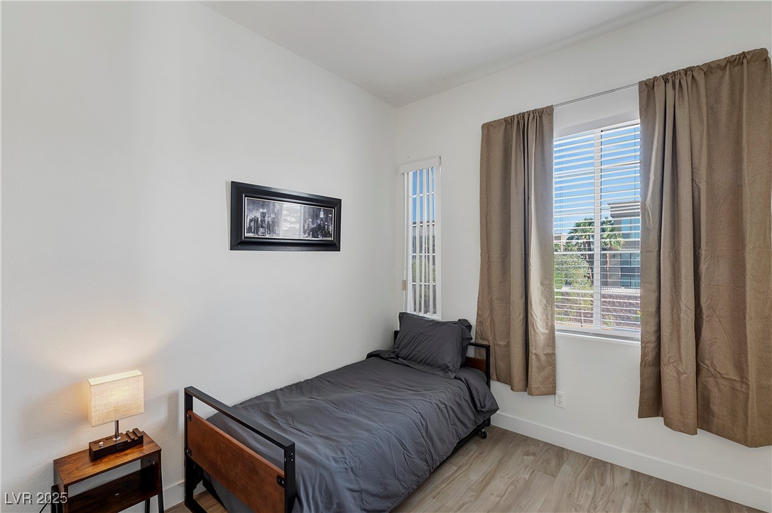 9156 Sapphire Point Avenue Las Vegas, NV 89147 - Photo 10 of 18 Bedroom featuring baseboards and light wood-style