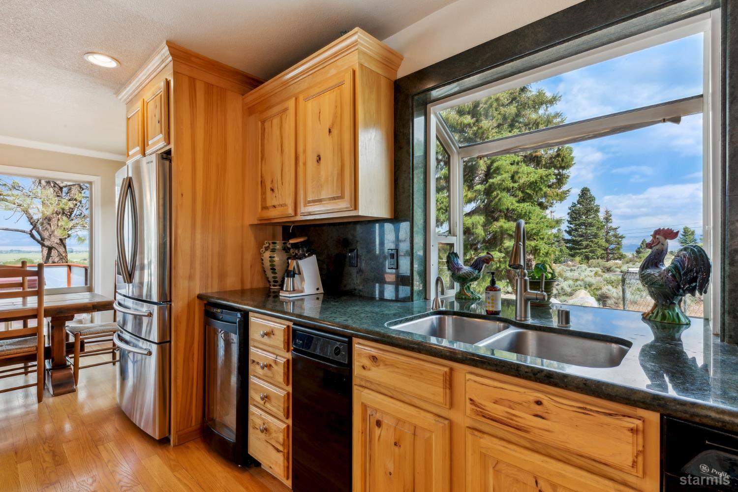 1299 Kingsbury Grade Road Gardnerville, NV 89460 - Photo 14 of 37 a kitchen with stainless steel appliances a sink a counter space and a window