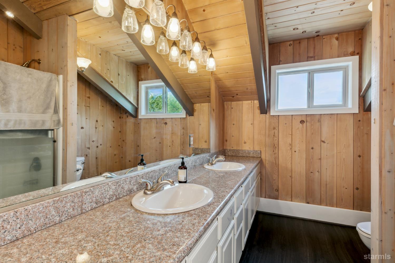 1299 Kingsbury Grade Road Gardnerville, NV 89460 - Photo 26 of 37 a bathroom with a sink a mirror and a shower
