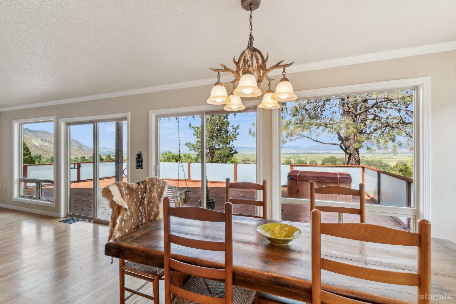 1299 Kingsbury Grade Road Gardnerville, NV 89460 - Photo 9 of 37 a dining room with wooden floor a chandelier a glass table and chairs