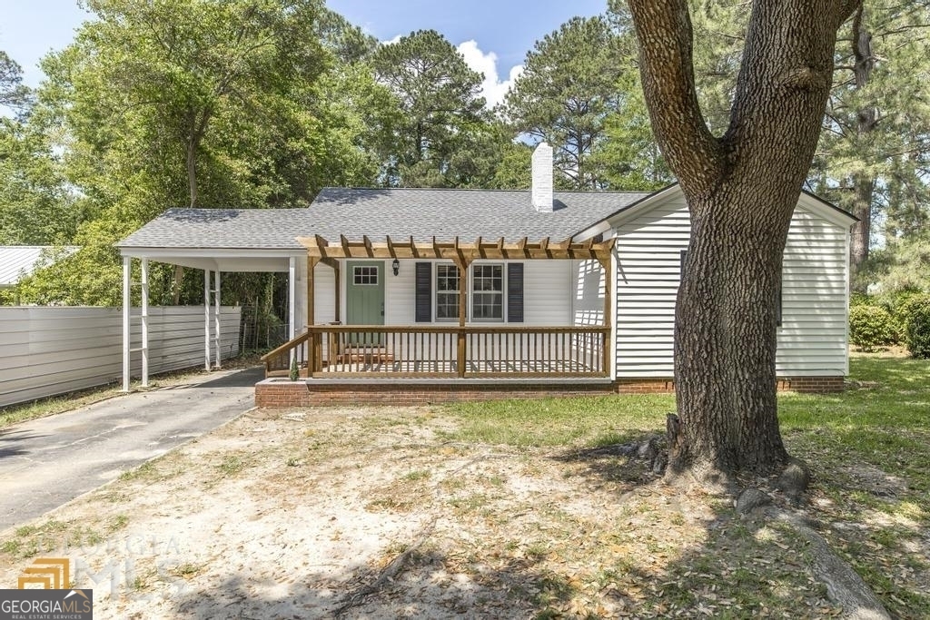 a view of a house with a yard and balcony
