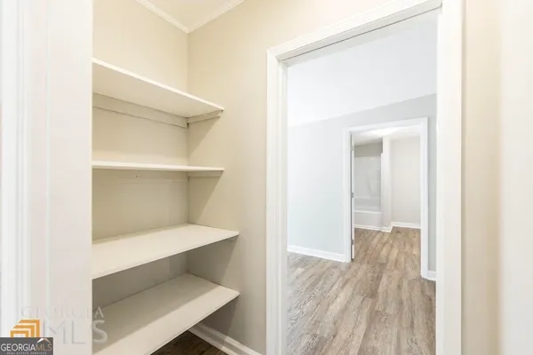 a view of a hallway with wooden floor