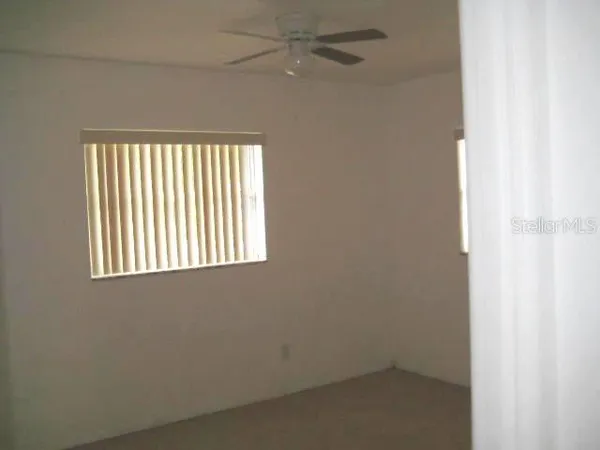 a backyard of a house with lots of green space and plants