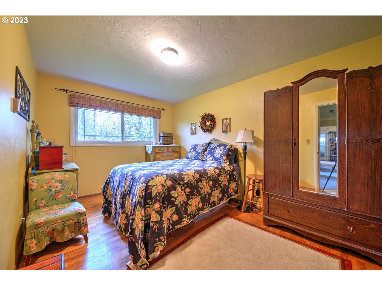 1267 N Street Springfield, OR 97477 - Photo 14 of 27 a bed sitting in a bedroom next to a window