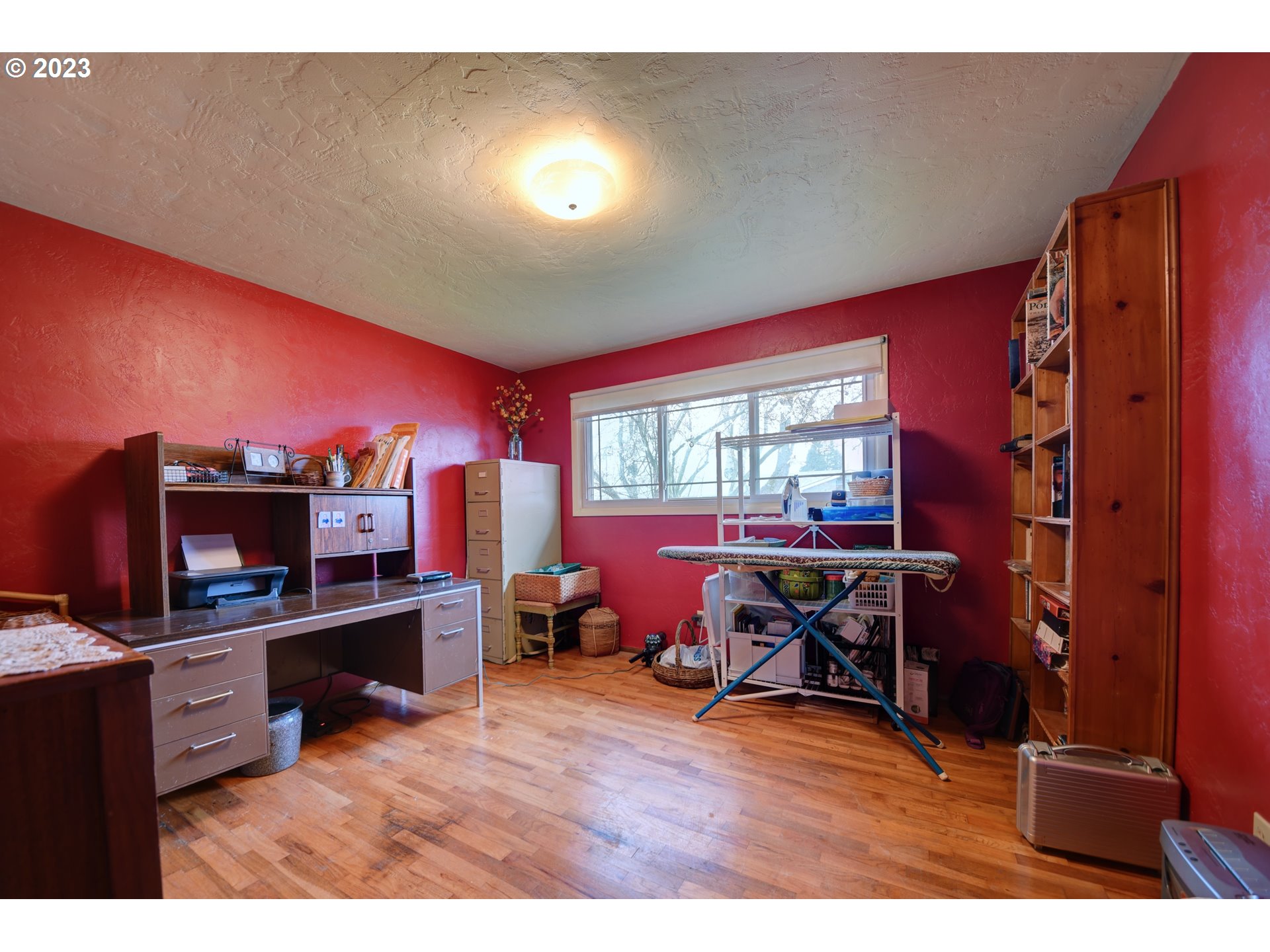 1267 N Street Springfield, OR 97477 - Photo 20 of 27 a living room with furniture a flat screen tv and floor to ceiling window