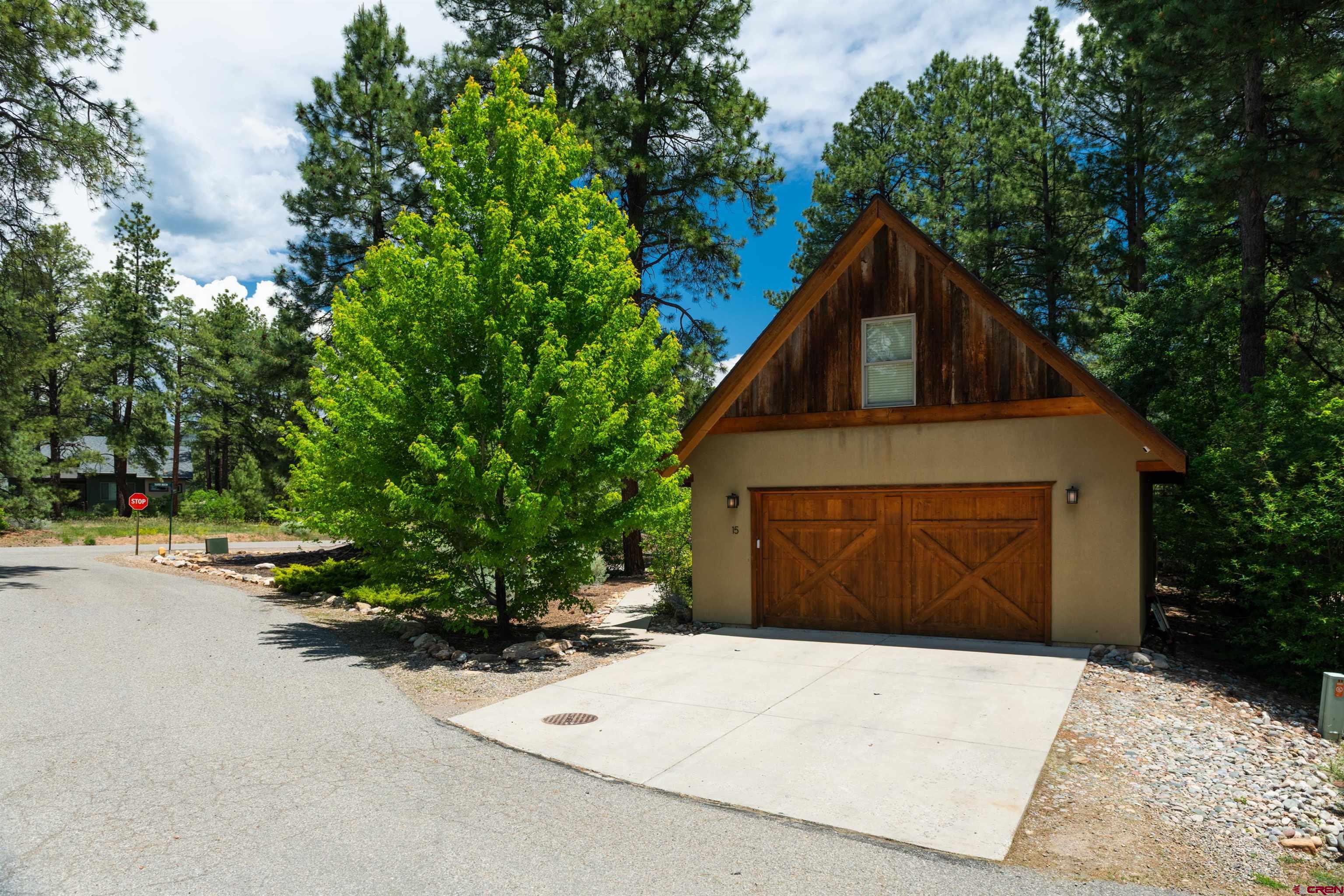 15 Edgemont Way Durango, CO 81301 - Photo 17 of 35 a front view of a house with a yard and garage