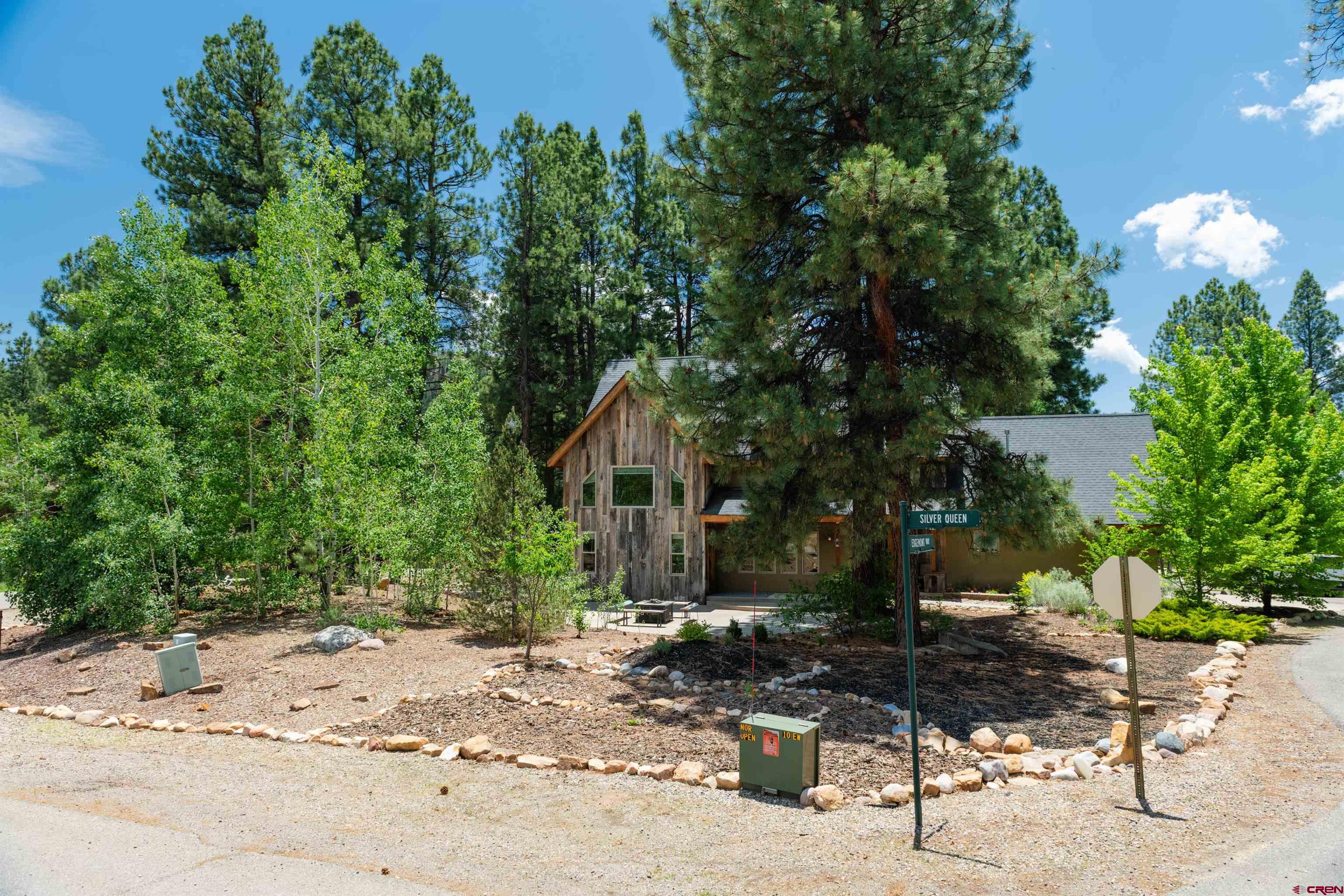 15 Edgemont Way Durango, CO 81301 - Photo 2 of 35 a front view of a house with a yard and sitting area