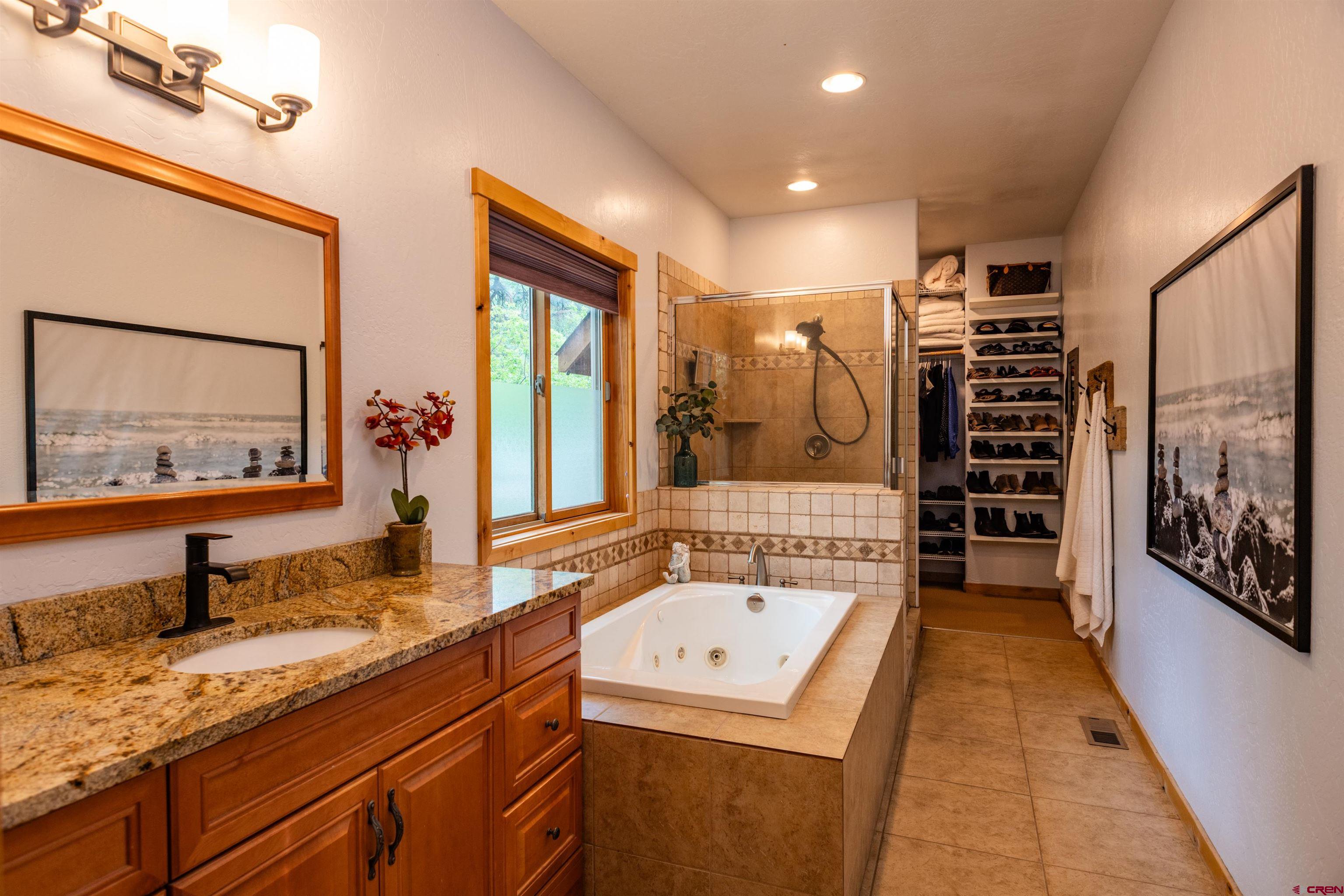 15 Edgemont Way Durango, CO 81301 - Photo 26 of 35 a spacious bathroom with a shower sink and mirror