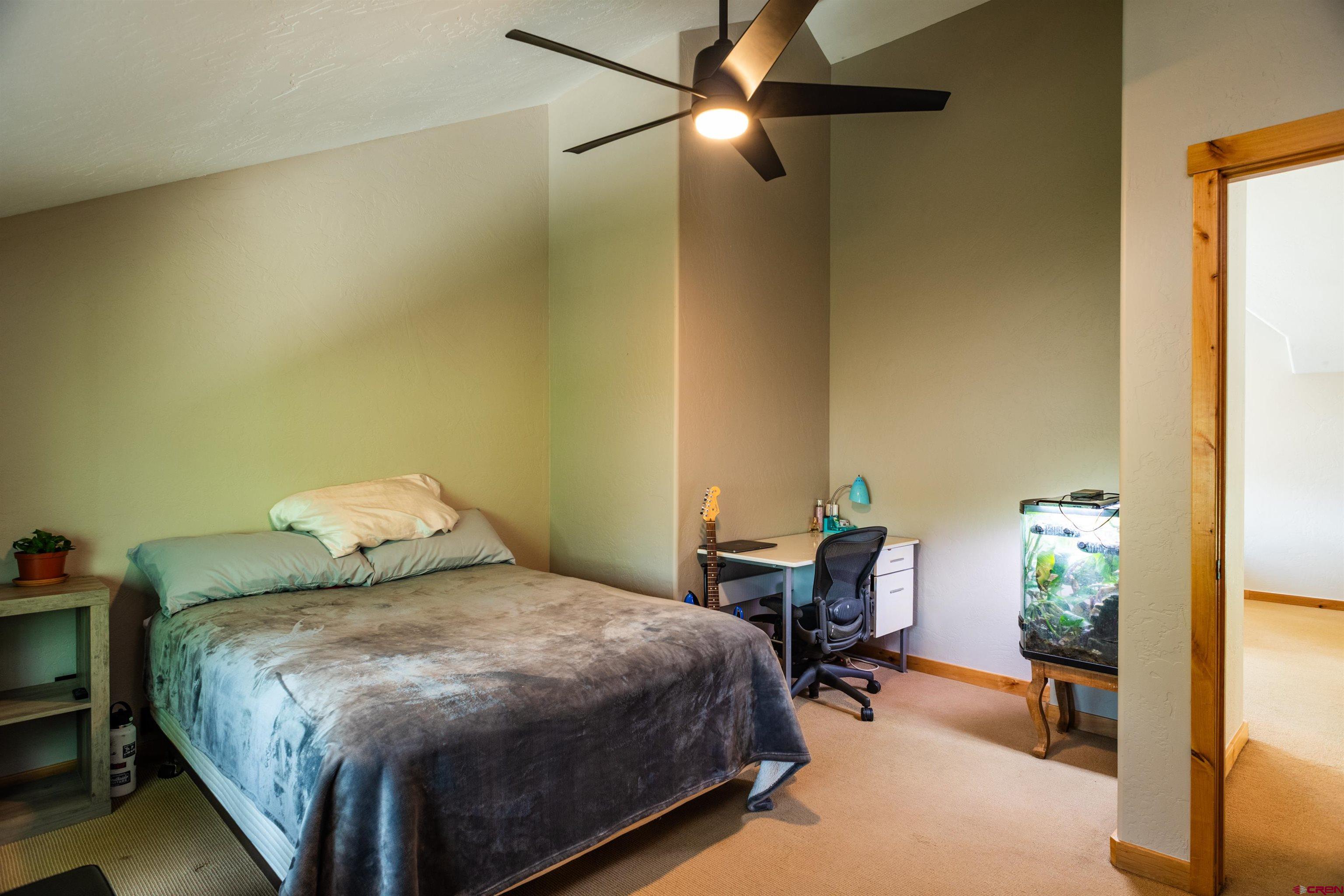 15 Edgemont Way Durango, CO 81301 - Photo 31 of 35 a bedroom with a bed and a chandelier