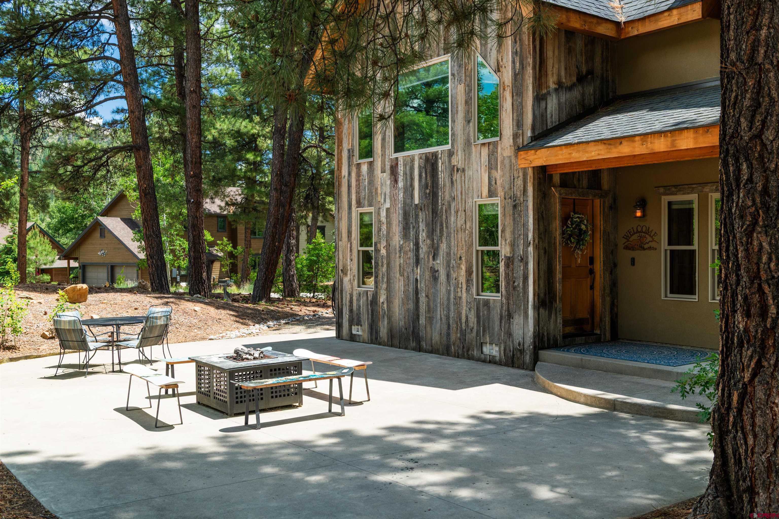 15 Edgemont Way Durango, CO 81301 - Photo 4 of 35 a view of a patio with table and chairs with wooden fence and plants