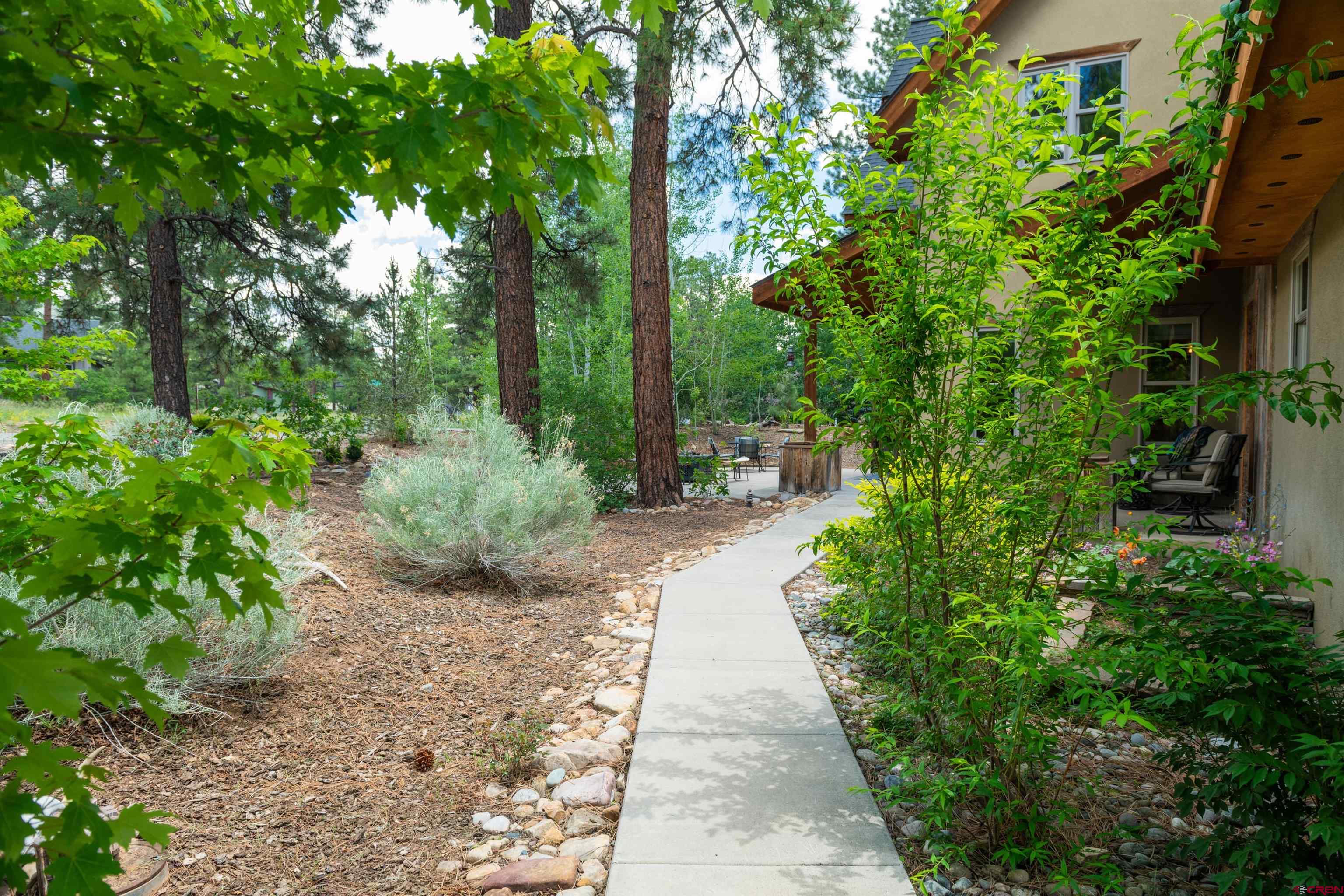 15 Edgemont Way Durango, CO 81301 - Photo 8 of 35 a view of a pathway with plants and large trees
