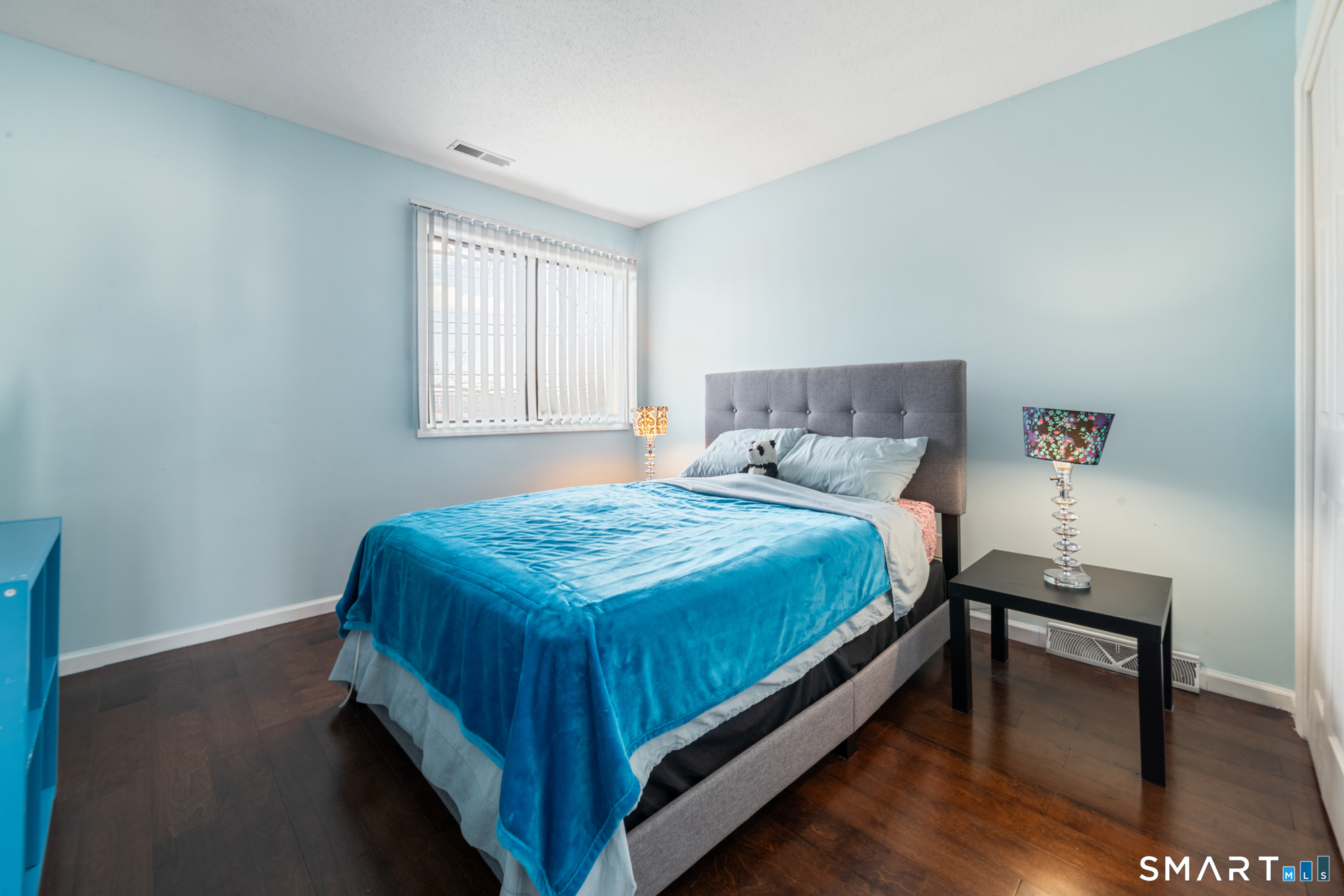 900 Mix Avenue, Unit 123 Hamden, CT 06514 - Photo 17 of 32 a bed sitting in a bedroom next to a window with a table