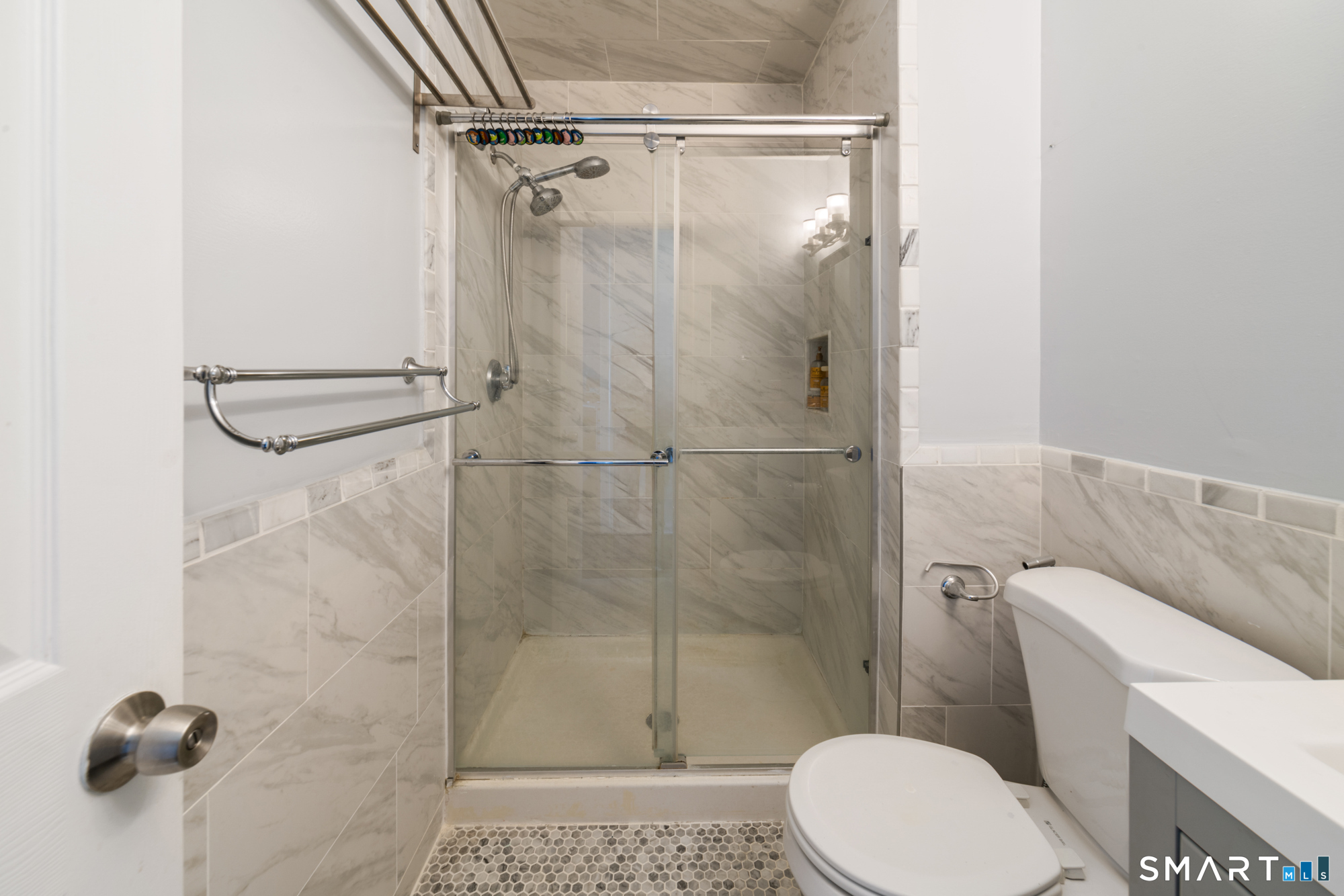 900 Mix Avenue, Unit 123 Hamden, CT 06514 - Photo 26 of 32 a white toilet sitting next to a bathroom