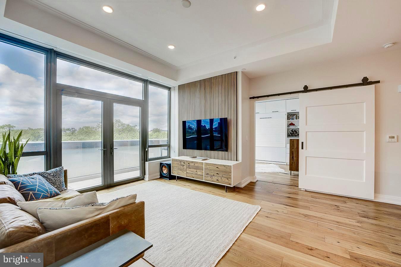 1111 Pennsylvania Ave. Southeast, Unit 409 Washington, DC 20003 - Photo 3 of 26 a living room with furniture and a flat screen tv