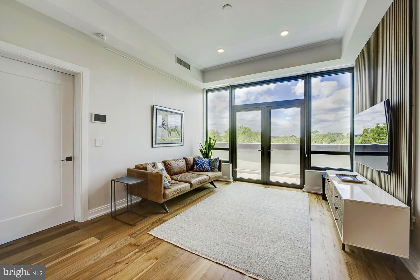 1111 Pennsylvania Ave. Southeast, Unit 409 Washington, DC 20003 - Photo 4 of 26 a spacious bedroom with a large bed and a large window