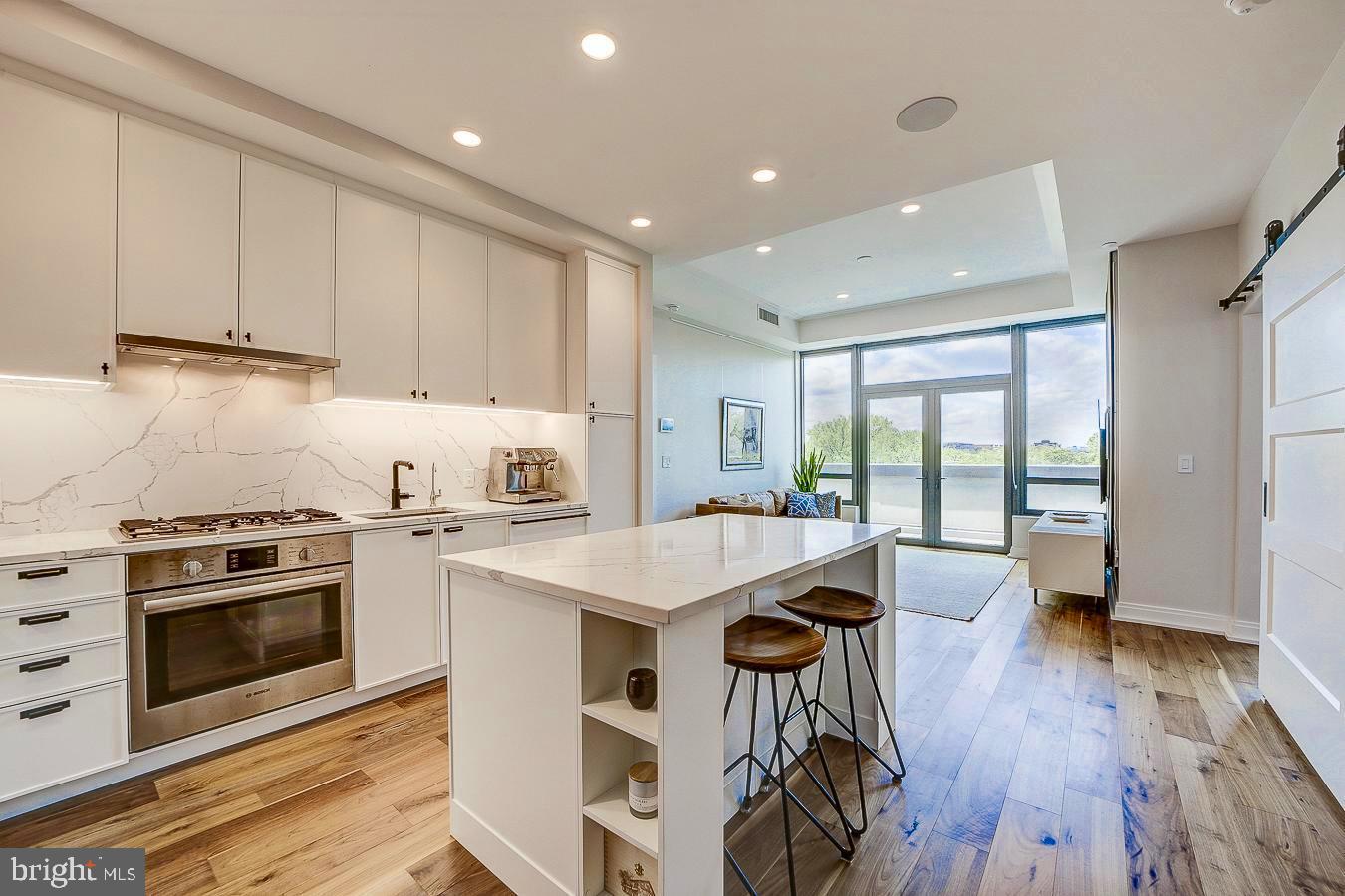 1111 Pennsylvania Ave. Southeast, Unit 409 Washington, DC 20003 - Photo 7 of 26 a kitchen with a stove a sink and a refrigerator