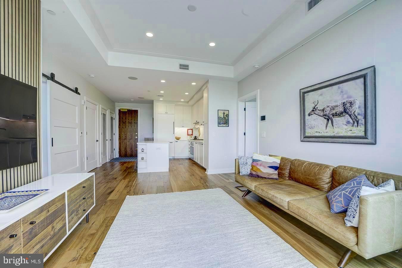 1111 Pennsylvania Ave. Southeast, Unit 409 Washington, DC 20003 - Photo 10 of 26 a large living room with stainless steel appliances