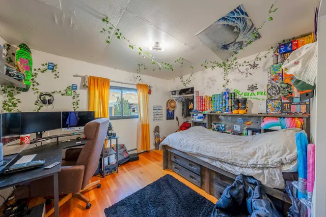 a bedroom with a bed and a desk