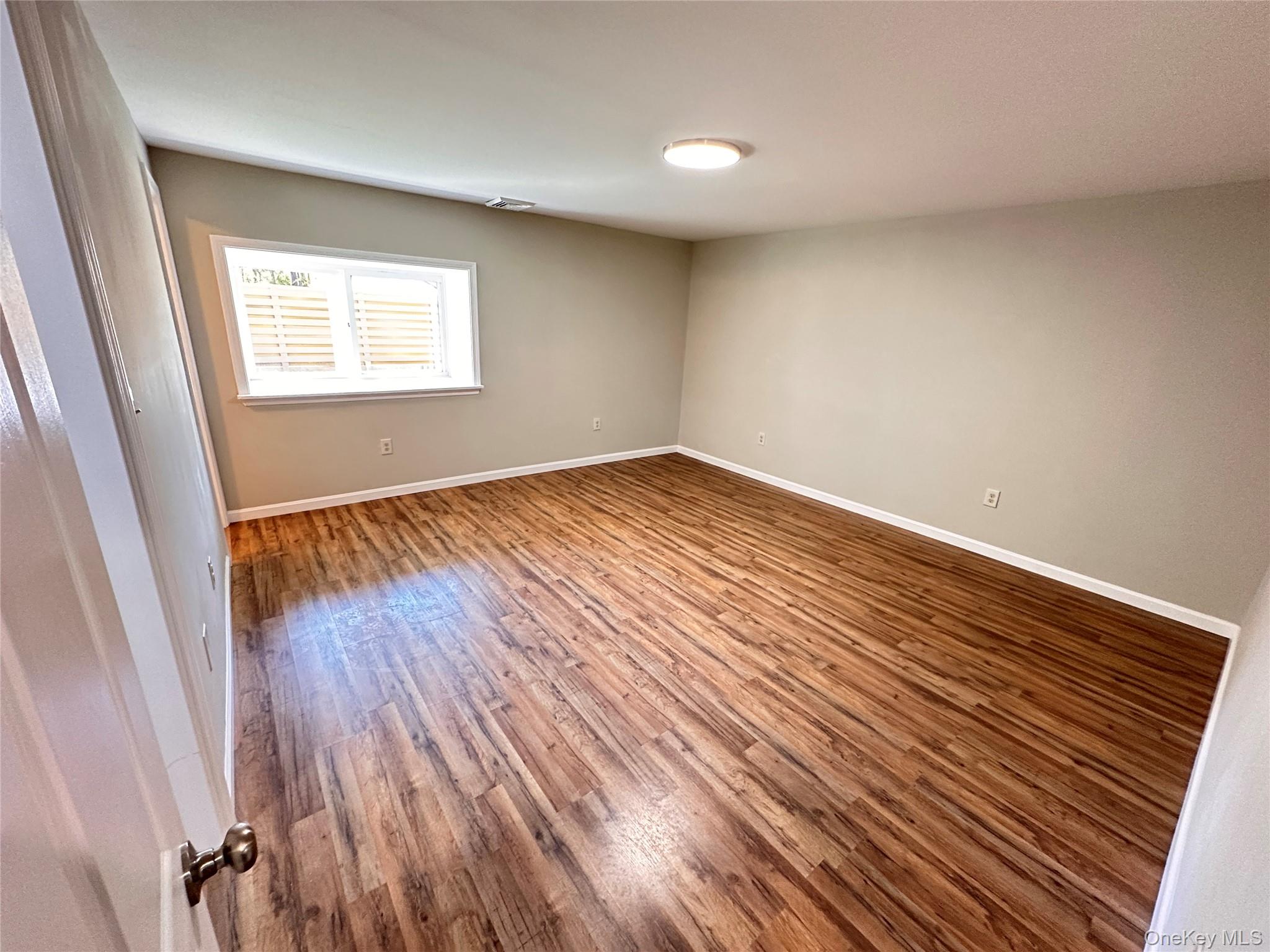 525 Plattekill Ardonia Road Wallkill, NY 12589 - Photo 12 of 25 a view of an empty room with wooden floor and a window