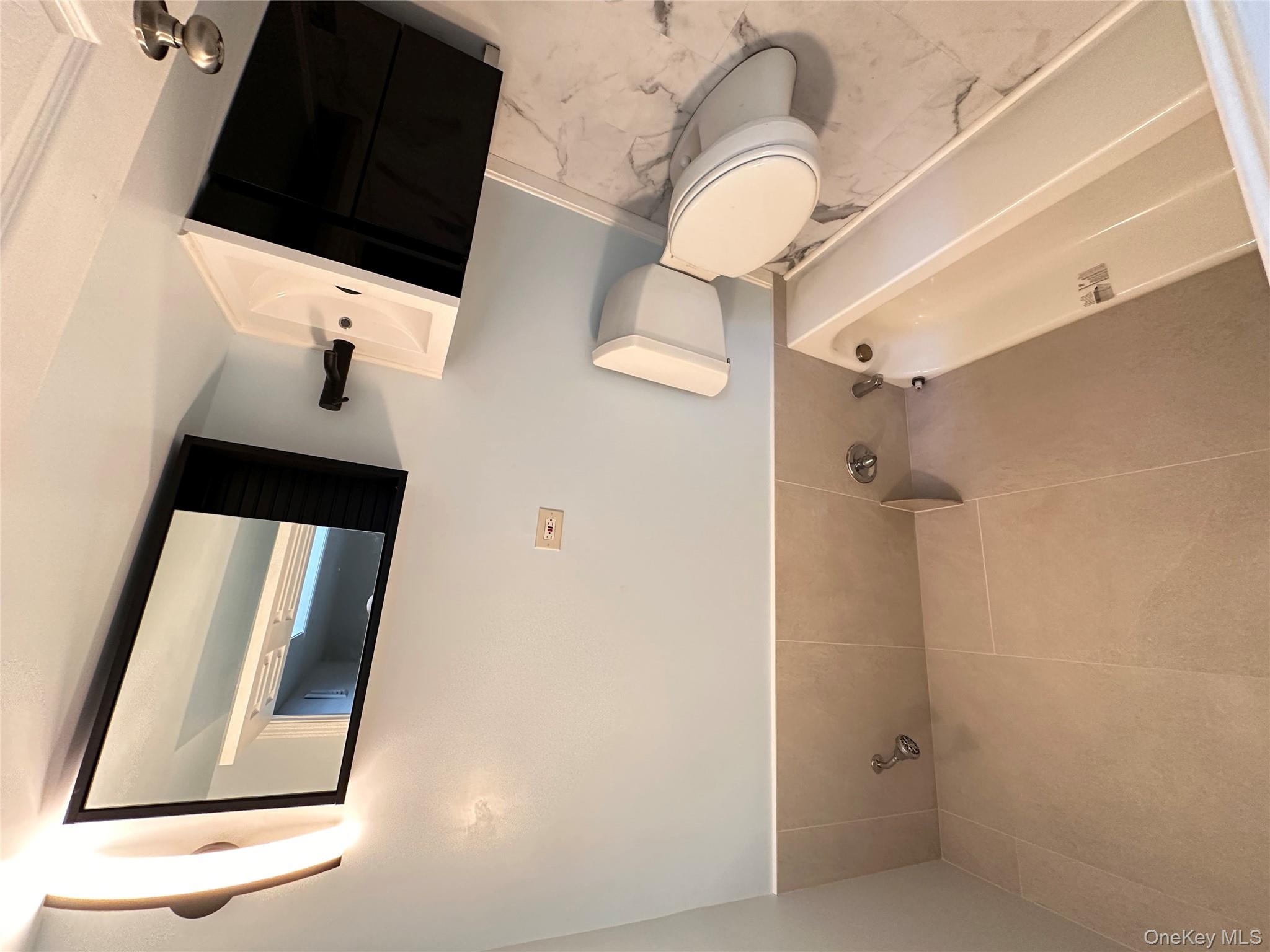 525 Plattekill Ardonia Road Wallkill, NY 12589 - Photo 13 of 25 a bathroom with a toilet a sink a tub and mirror