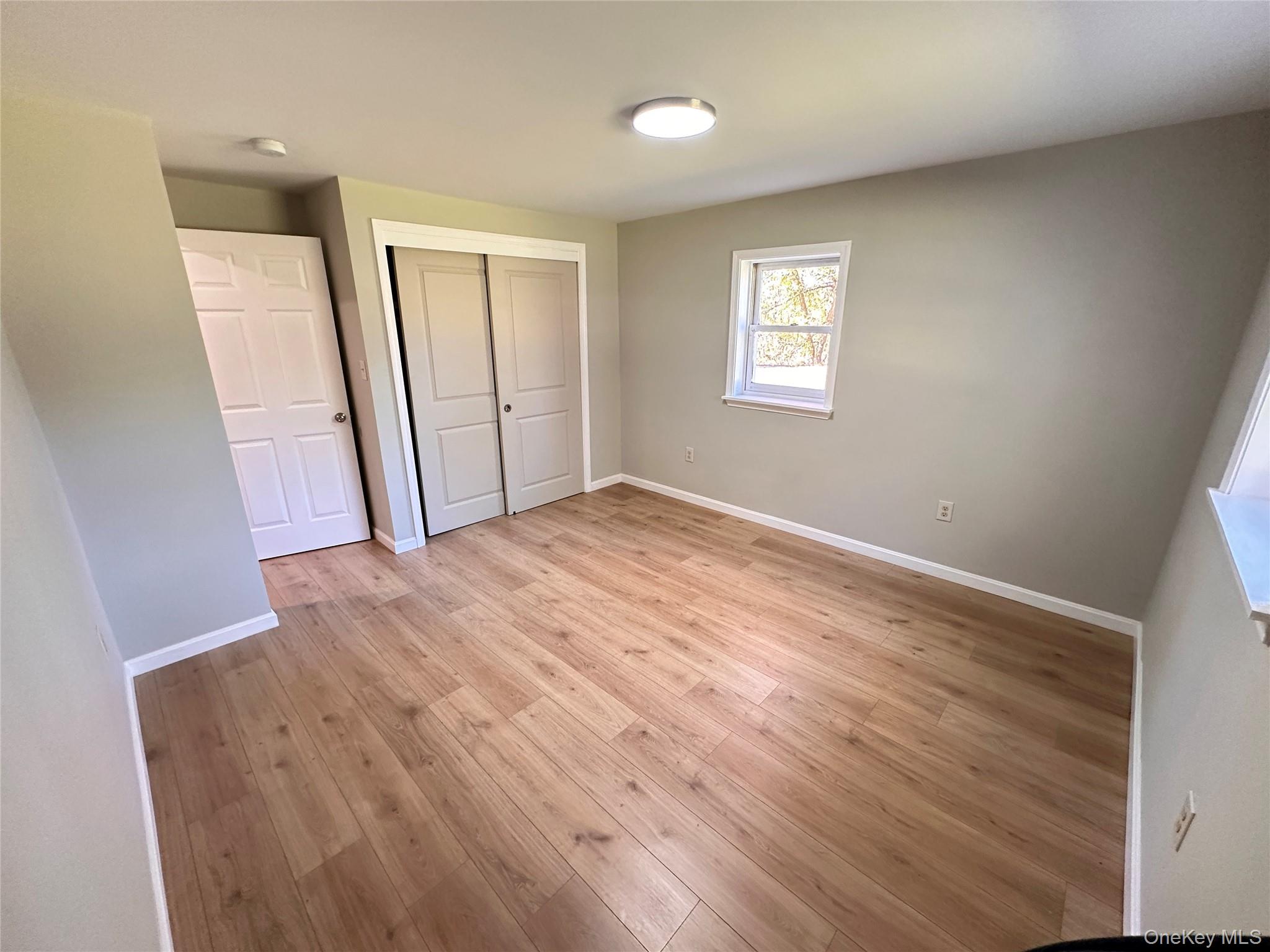 525 Plattekill Ardonia Road Wallkill, NY 12589 - Photo 16 of 25 wooden floor in an empty room with a window