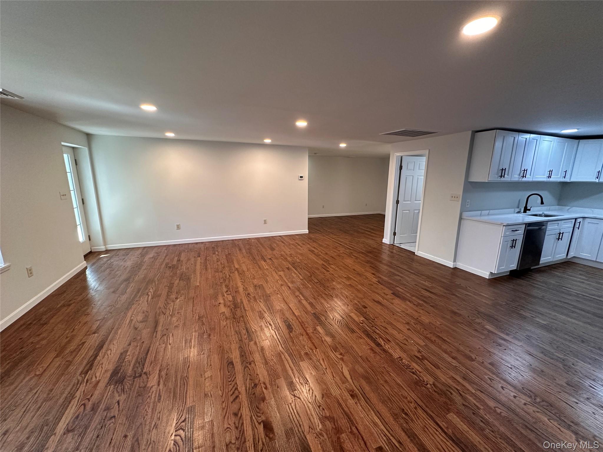 525 Plattekill Ardonia Road Wallkill, NY 12589 - Photo 7 of 25 an empty room with wooden floor and windows