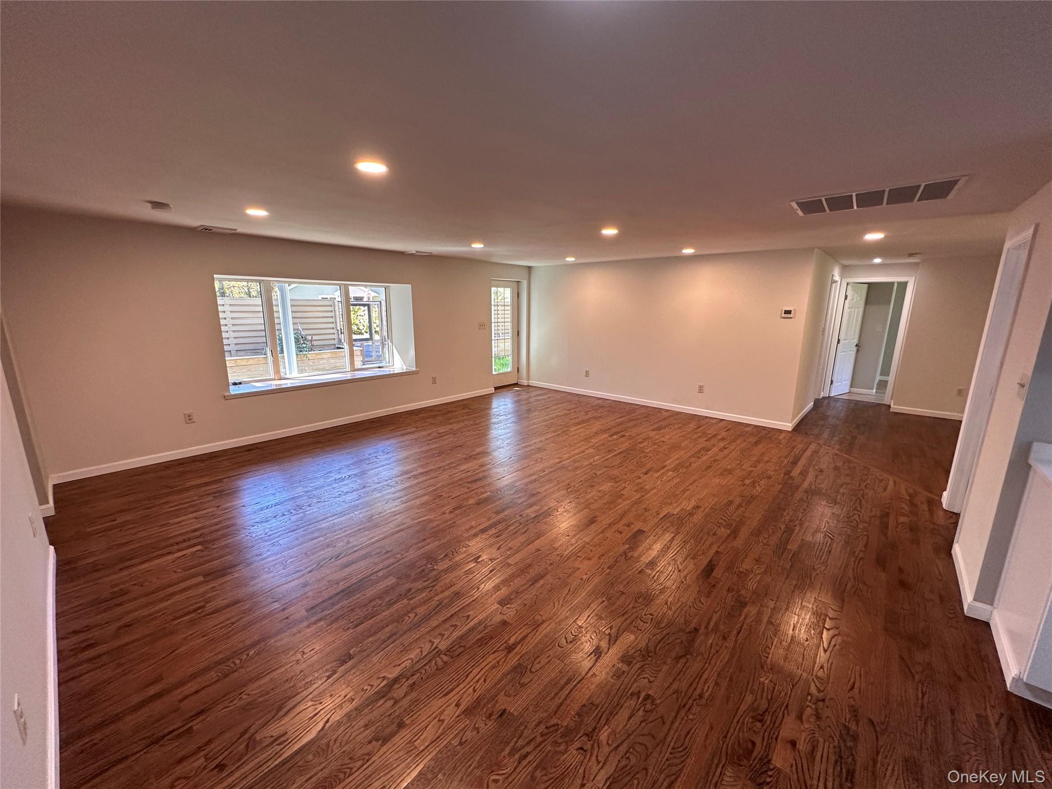 525 Plattekill Ardonia Road Wallkill, NY 12589 - Photo 8 of 25 an empty room with wooden floor and windows