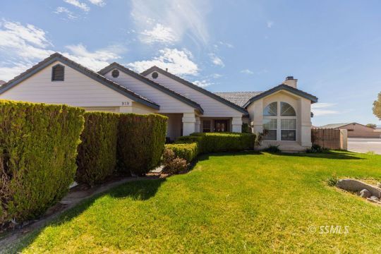 919 Beverly Court Ridgecrest, CA 93555 - Photo 2 of 29 a front view of a house with a yard