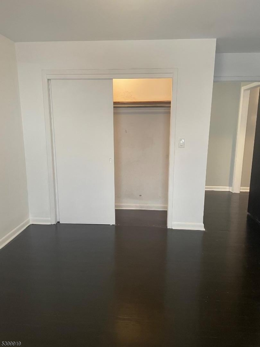 113 Hawthorne Avenue, Unit 2 Hawthorne, NJ 07506 - Photo 14 of 18 a view of an empty room with wooden floor and a window