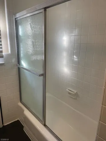 a bathroom with a glass shower door