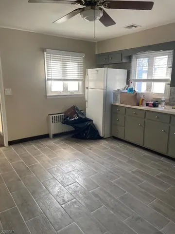 a kitchen with refrigerator and window