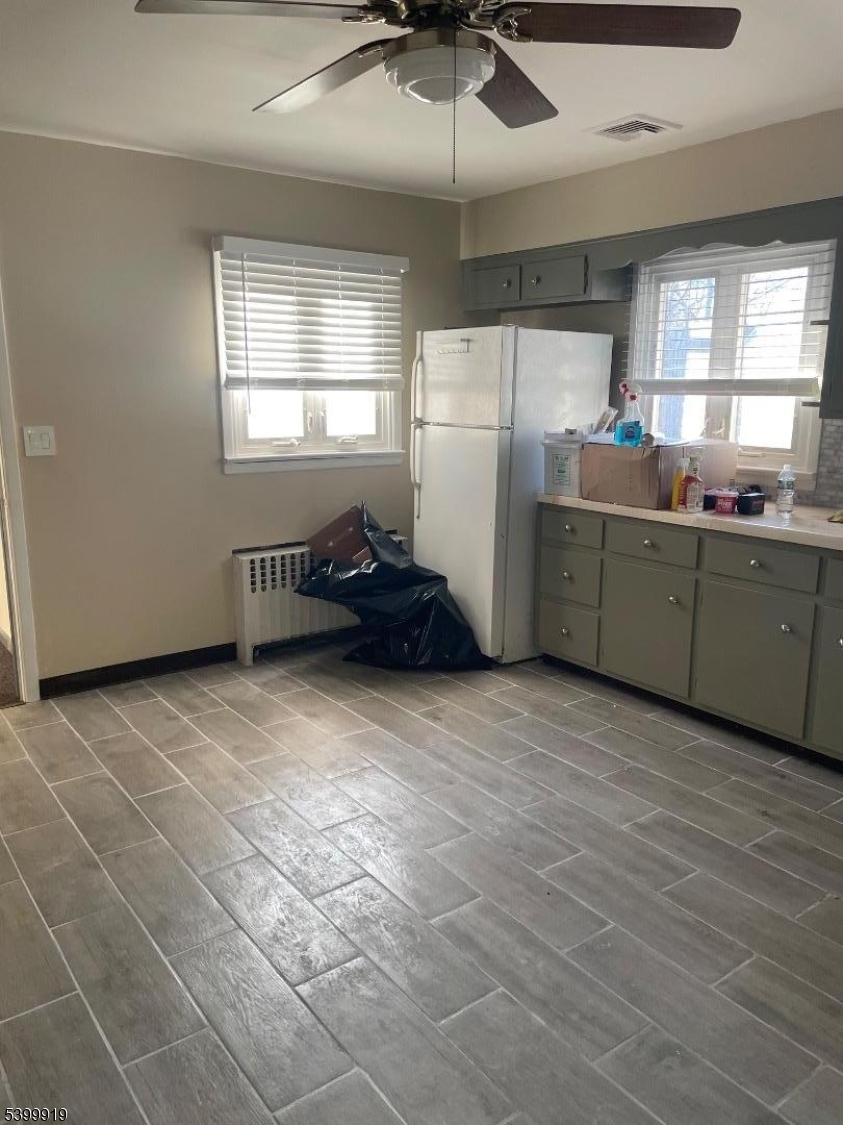 113 Hawthorne Avenue, Unit 2 Hawthorne, NJ 07506 - Photo 6 of 18 a kitchen with refrigerator and window