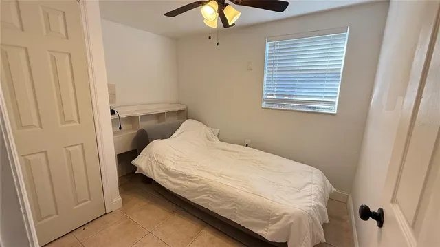 a bedroom with a bed and chandelier