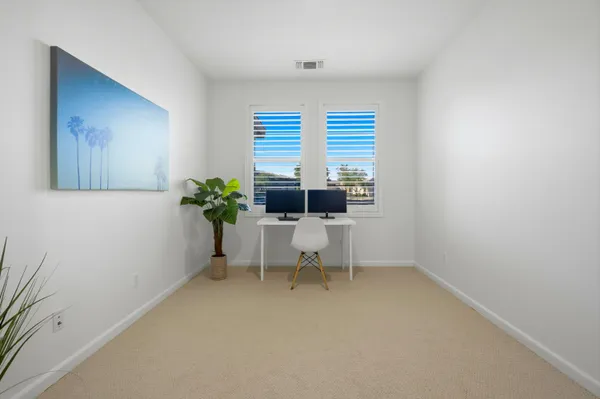 a living room with furniture and a potted plant