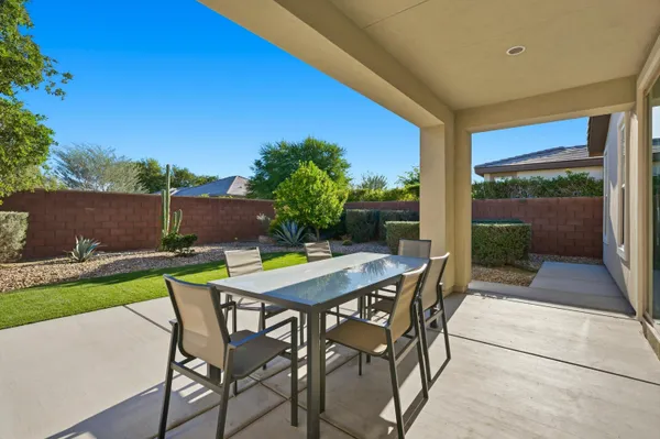 a view of an outdoor dining space with a table and chairs