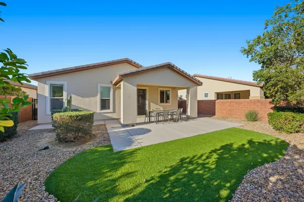 a front view of a house with patio and garden