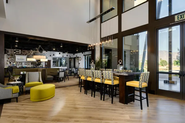 a living room with furniture and a floor to ceiling window