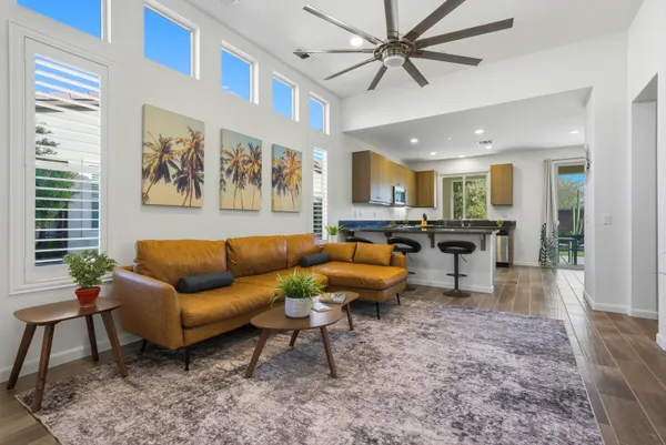a living room with furniture and a view of kitchen