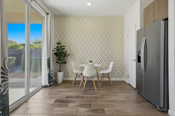 a dining room with furniture and a potted plant