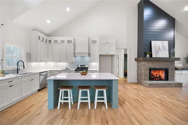 a view of a kitchen with a sink and a fireplace