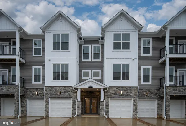 a front view of a residential apartment building with a yard