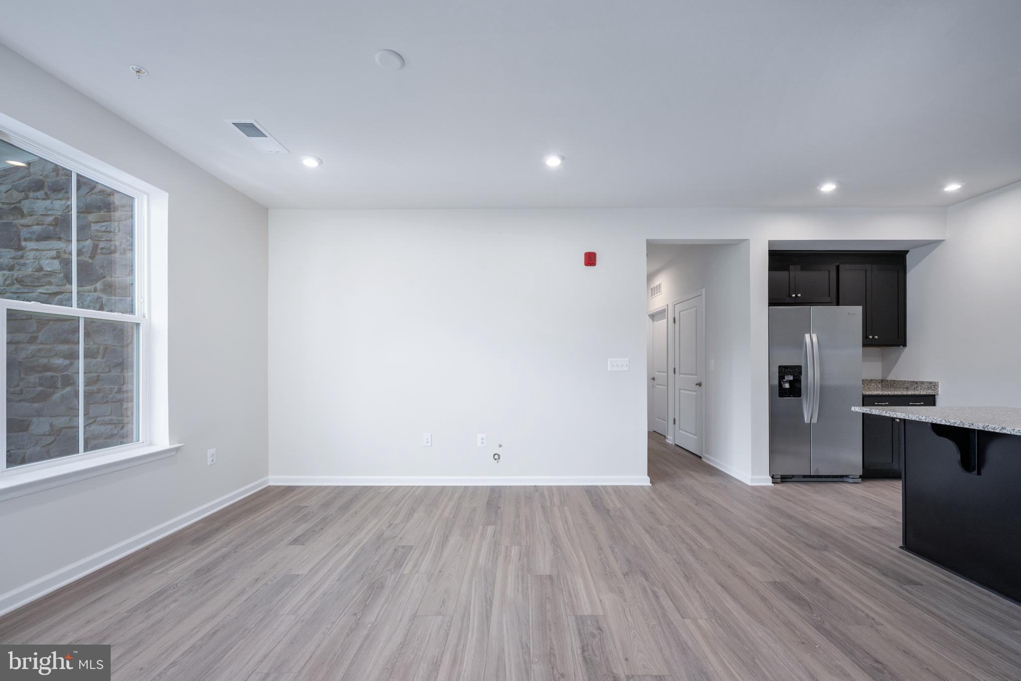 29 Hyssop Way, Unit 101 Stafford, VA 22554 - Photo 13 of 34 an empty room with wooden floor and entrance to ceiling window