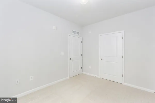 a spacious bathroom with a double vanity sink toilet mirror and bathtub