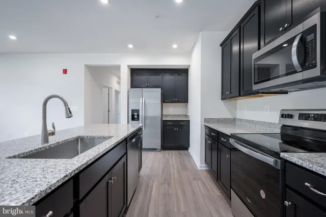 a kitchen with a refrigerator and a sink
